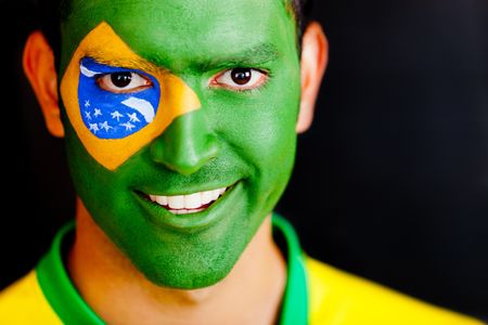 Patriotic man from Brazil with flag painted on his face