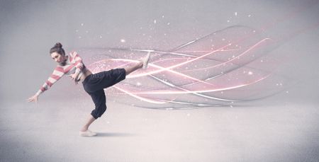 A pretty hip hop dancer dancing contemporary dance illustrated with glowing motion lines in the background concept.