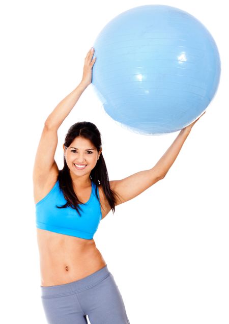 Woman exercising with Pilates ball - isolated over a white background