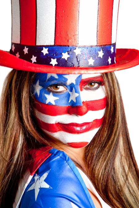 American woman with the USA flag painted on her face and a hatÃ?Â?Ã?Â� isolated