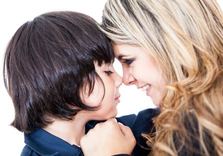Potrait of a mother and son giving an eskimo kiss - isolated over white