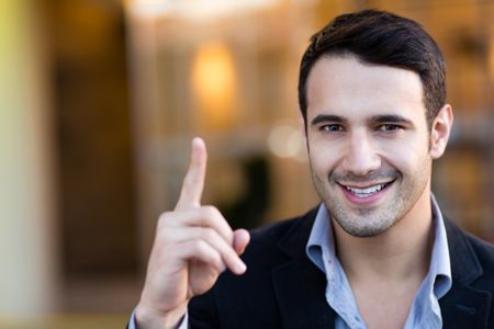 Successful businessman pointing an idea and smiling
