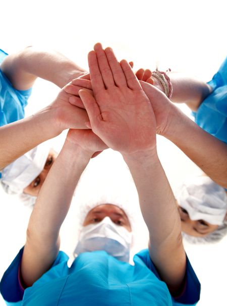 doctors with hands together to form a medical teamwork - isolated over a white background