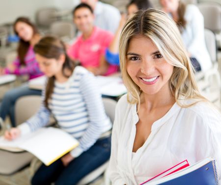 Happy female student smiling in a classroom