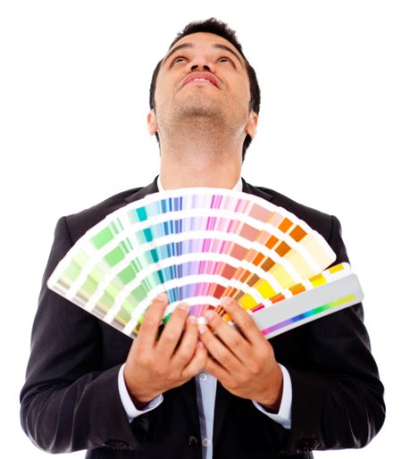 Pensive man holding a color guide - isolataed over a white backround