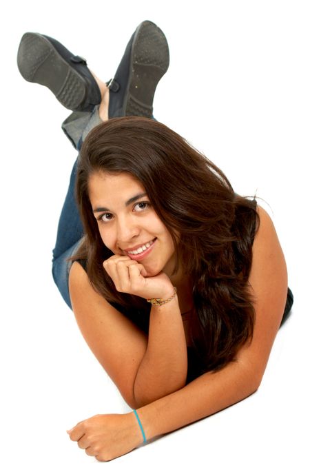 casual girl smiling on the floor isolated over a white background