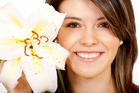 healthy girl smiling portrait holding a flower next to her face - isolated over a white background