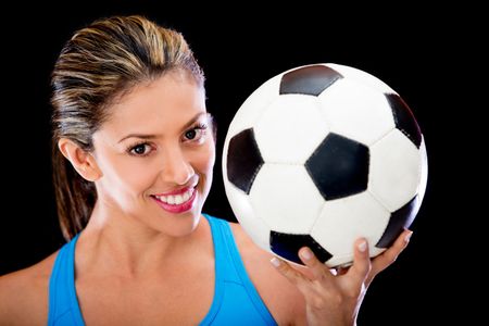 Woman holding a soccer ball - isolated over a black background