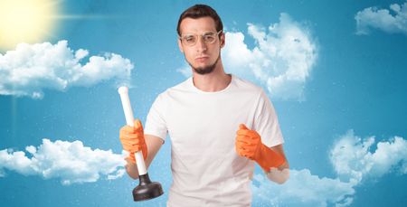Sunny and cloudy concept with male housekeeper and orange gloves on his hand