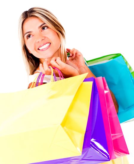 Beautiful shopping woman carrying bags - isolated over a white background