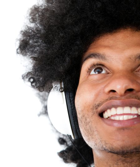Happy man listening to music with headphones - isolated over a white background