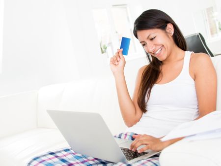 Happy woman to shopping online from home with a laptop