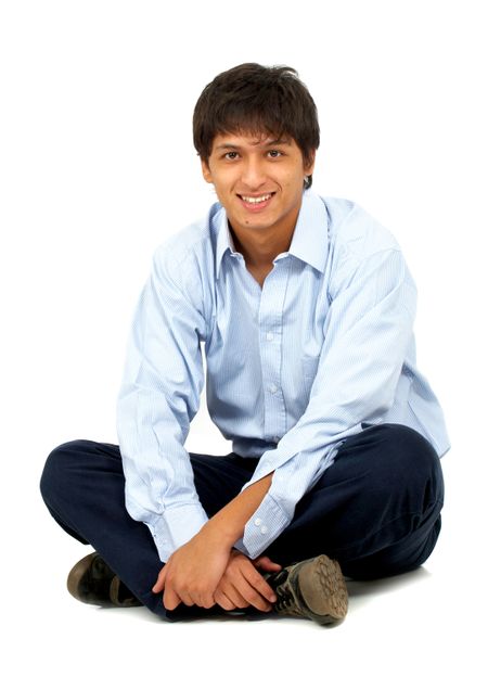 casual man sitting on the floor isolated over a white background