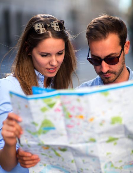 Lost tourists on their vacations looking at a map