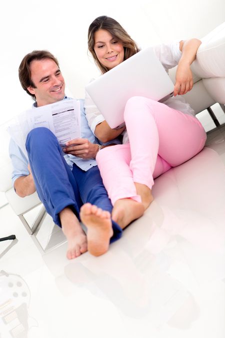Couple organising their home finances and looking happy