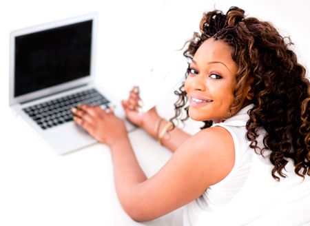 Woman working on a laptop looking happy