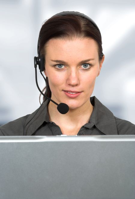 beautiful customer support girl in front of laptop in an office