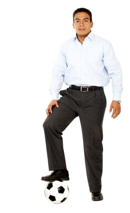 confident business man with a football isolated over a white background