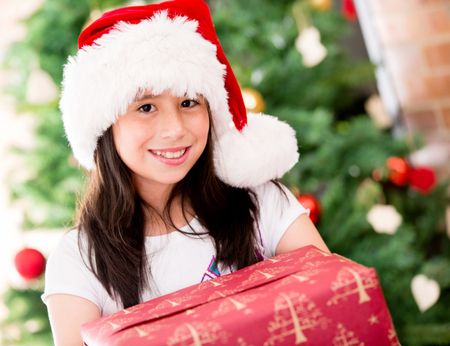 Beautiful Christmas portait of a girl holding a present