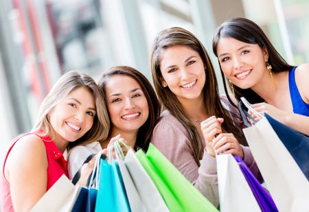 Group of beautiful shopping women holding bags