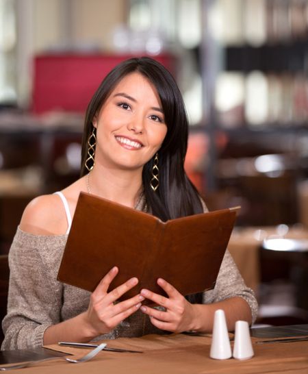 Woman in a restaurant looking at the menu
