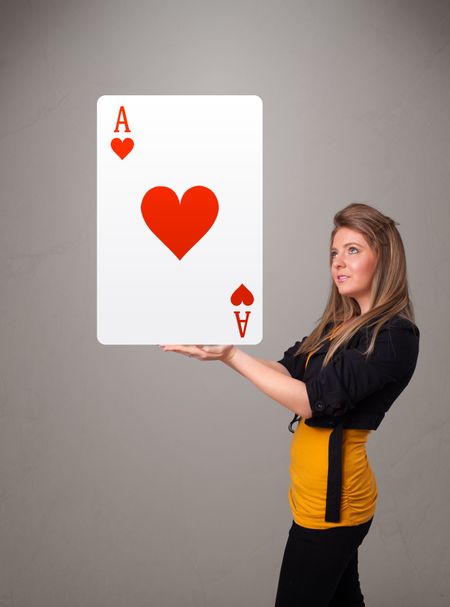 Beautifu young woman holding a red heart ace