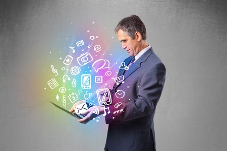 Middle aged businessman holding notebook with colorful hand drawn multimedia icons