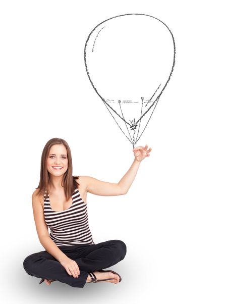 Pretty young woman holding balloon drawing