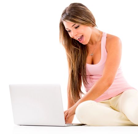Surprised woman using a laptop computer - isolated over white
