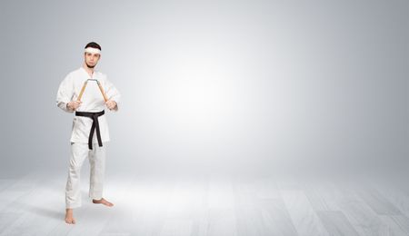 Young kung-fu trainer fighting in an empty space
