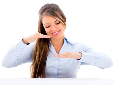 Business woman displaying something with her hands comparing - isolated over white