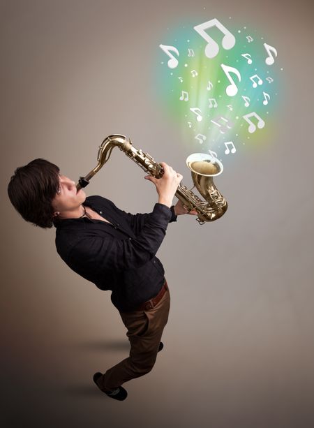 Attractive young musician playing on saxophone while musical notes exploding