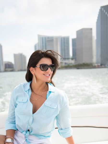 Beautiful woman in a boat enjoying the summer