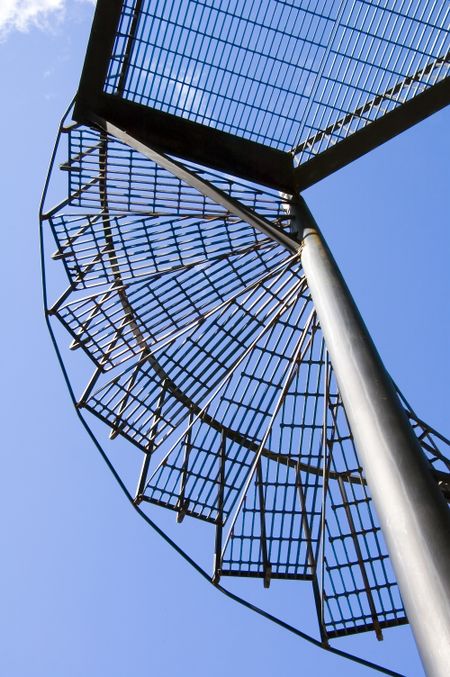 Spiral staircase to platform and blue sky