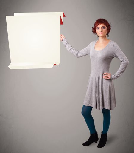 Baeutiful young woman holding white origami paper copy space