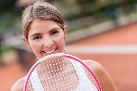 Portrait of a female tennis player with a racket