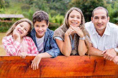 Portrait of a sweet family enjoying outdoors in the countryside