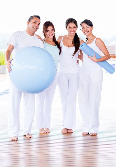 Group of people in a Pilates class looking happy