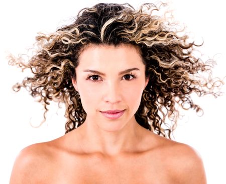 Beauty female portrait with curly hair in the wind - isolated over white