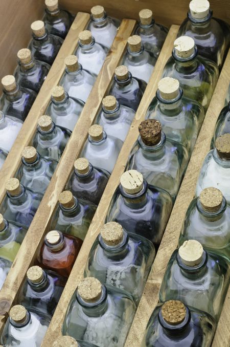 Antique medical arsenal: Corked glass bottles of medicine in wooden box during reenactment of a battle in the American Civil War (1861-1865)