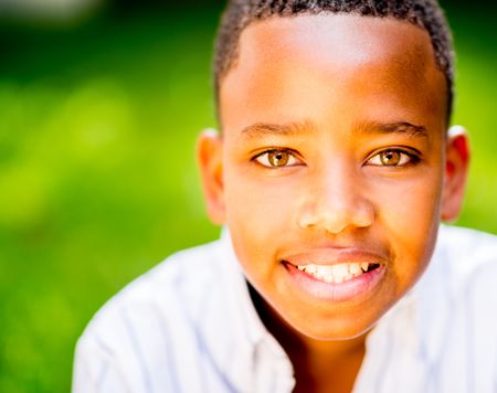 Portrait of a happy black boy smiling at the park 