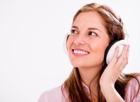 Happy woman with headphones - isolated over a white background 
