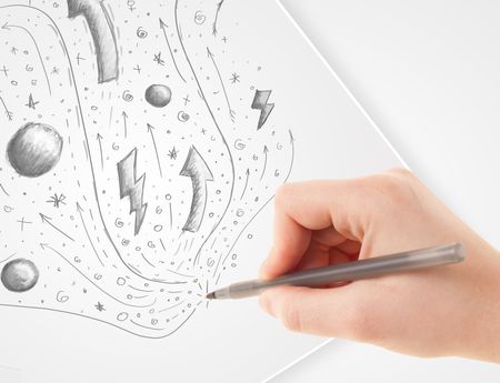 Hand drawing abstract sketches on a plain white paper