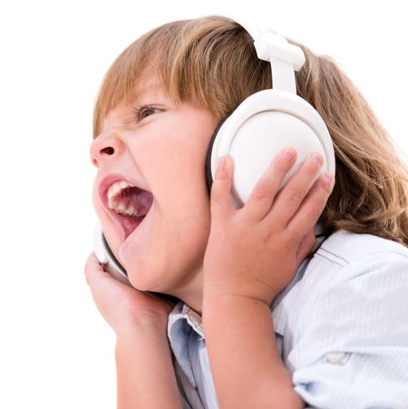 Little boy listening to music with headphones - isolated over white background 