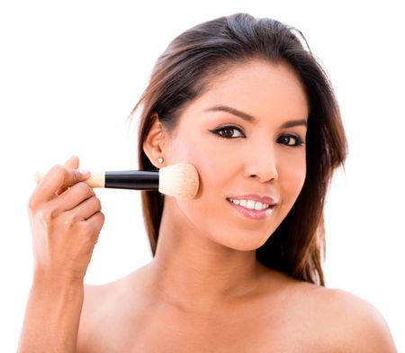 Beauty portrait of a woman applying makeup - isolated over white 