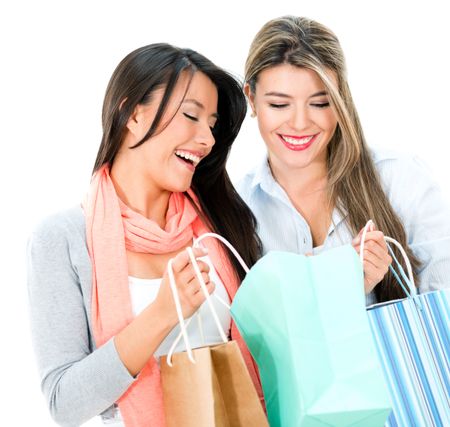 Happy shopping women looking at purchases - isolate dover white background