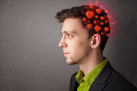 Young person thinking about love with glowing red hearts 