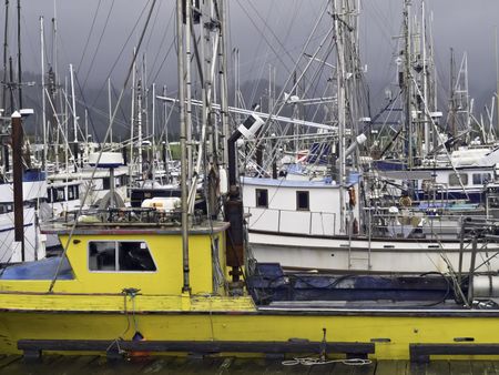 Harbor full of commercial and charter fishing vessels on a stormy day in Garibaldi, Oregon, USA