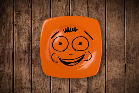 Happy smiley cartoon face on colorful dish plate and grungy background