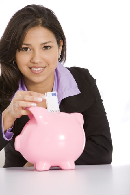 Beautiful business woman putting some money for her savings - isolated over a white background